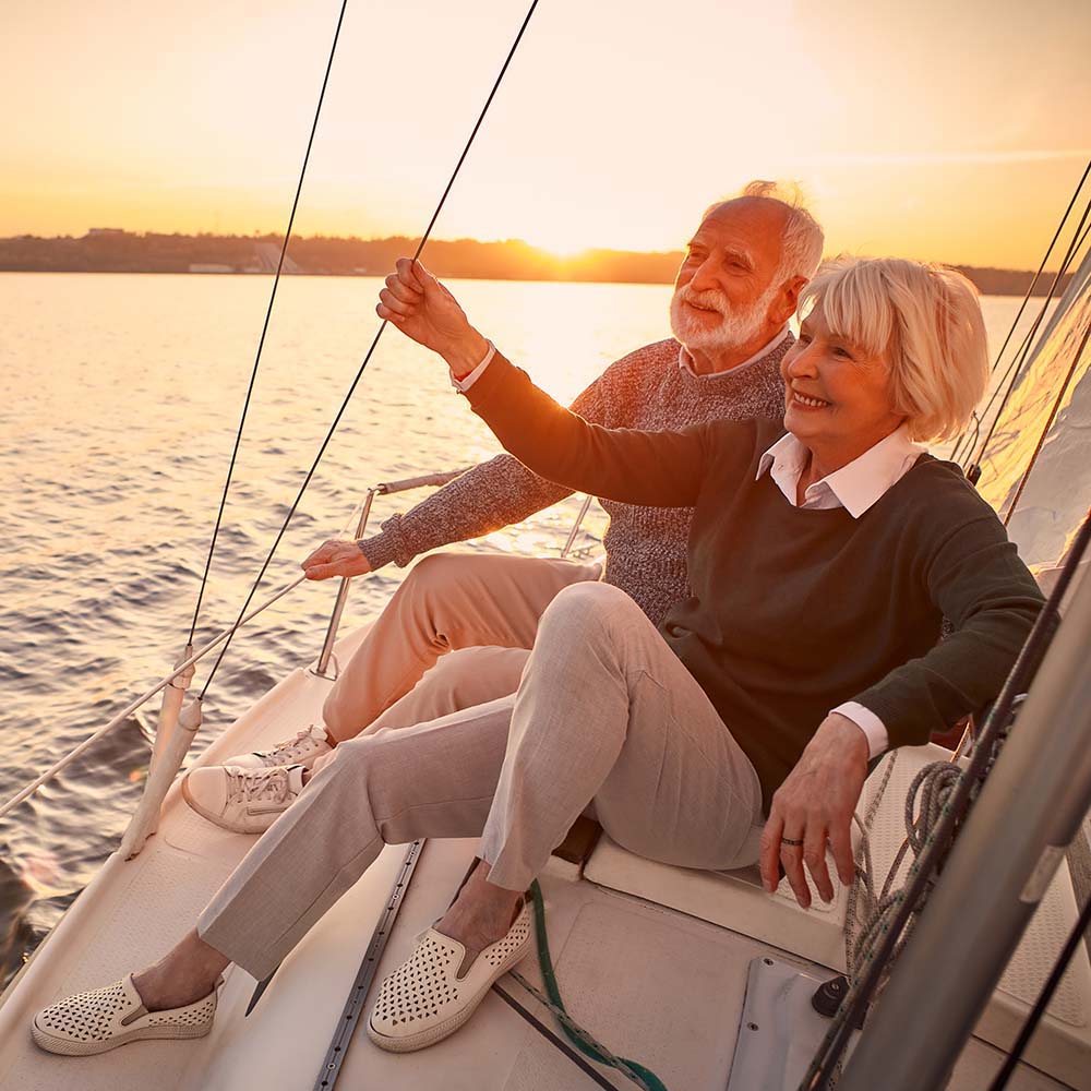 Couple sitting on boat in the marina at Portside Ventura Harbor in Ventura, California