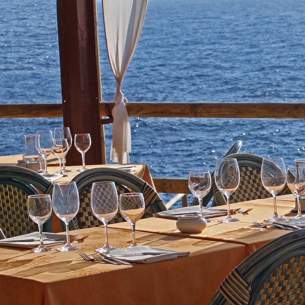 Seaside table set for the next guest at sunset at one of the restaurants near the marina at Portside Ventura Harbor in Ventura, California