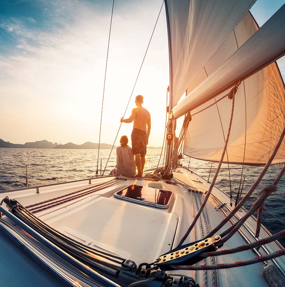 copule on the bow of a sailboat leaving the marina at Portside Ventura Harbor in Ventura, California