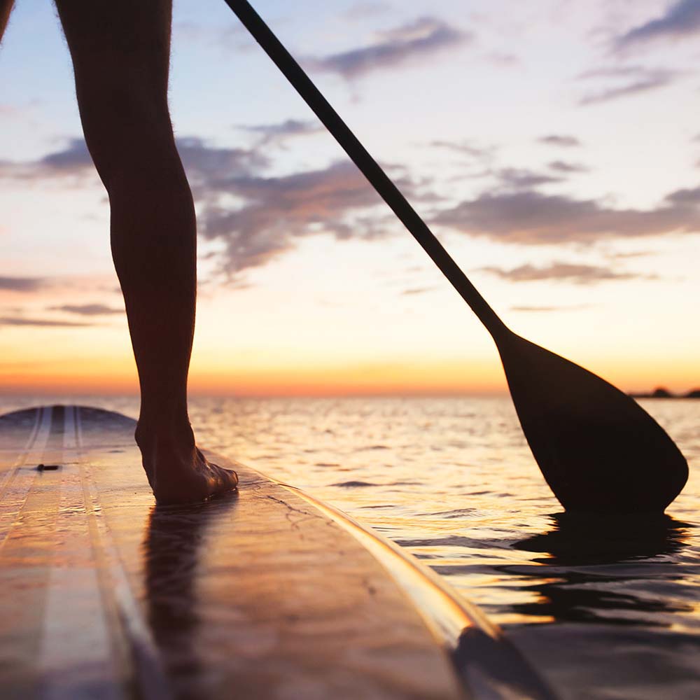 Woman on paddle board at Portside Ventura Harbor in Ventura, California